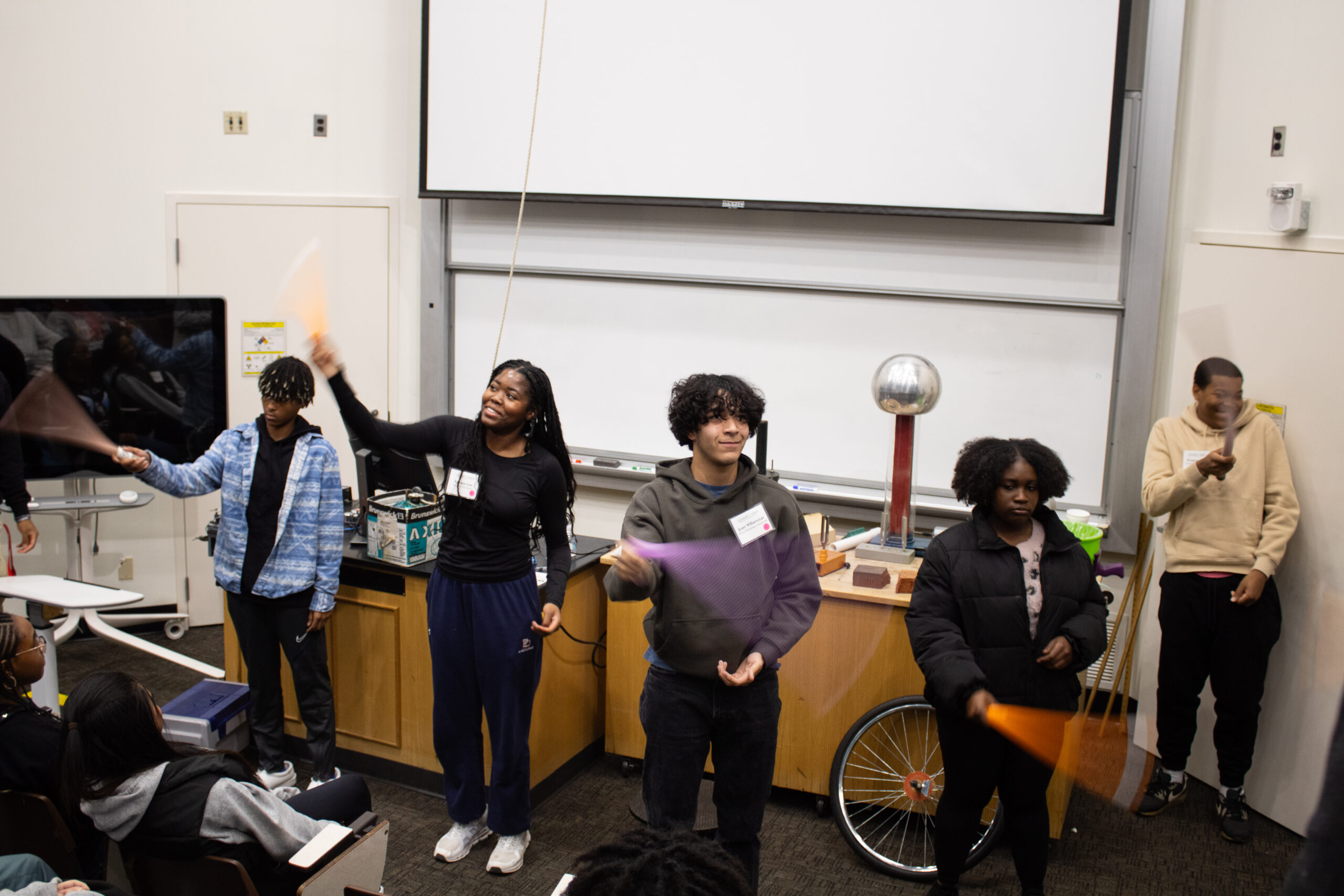 College LAUNCH students conducting a physics sounds experiment.