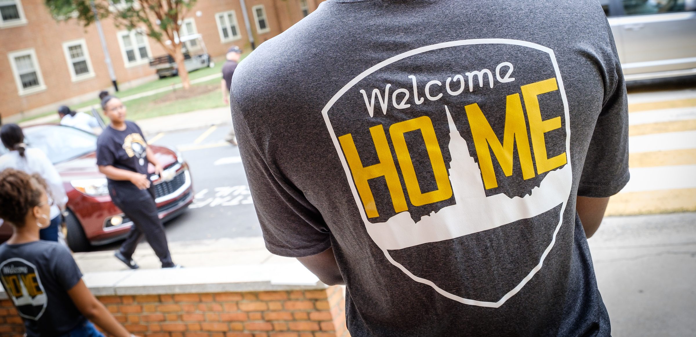 The Welcome Home logo as photographed on a tshirt of an RA during move in day