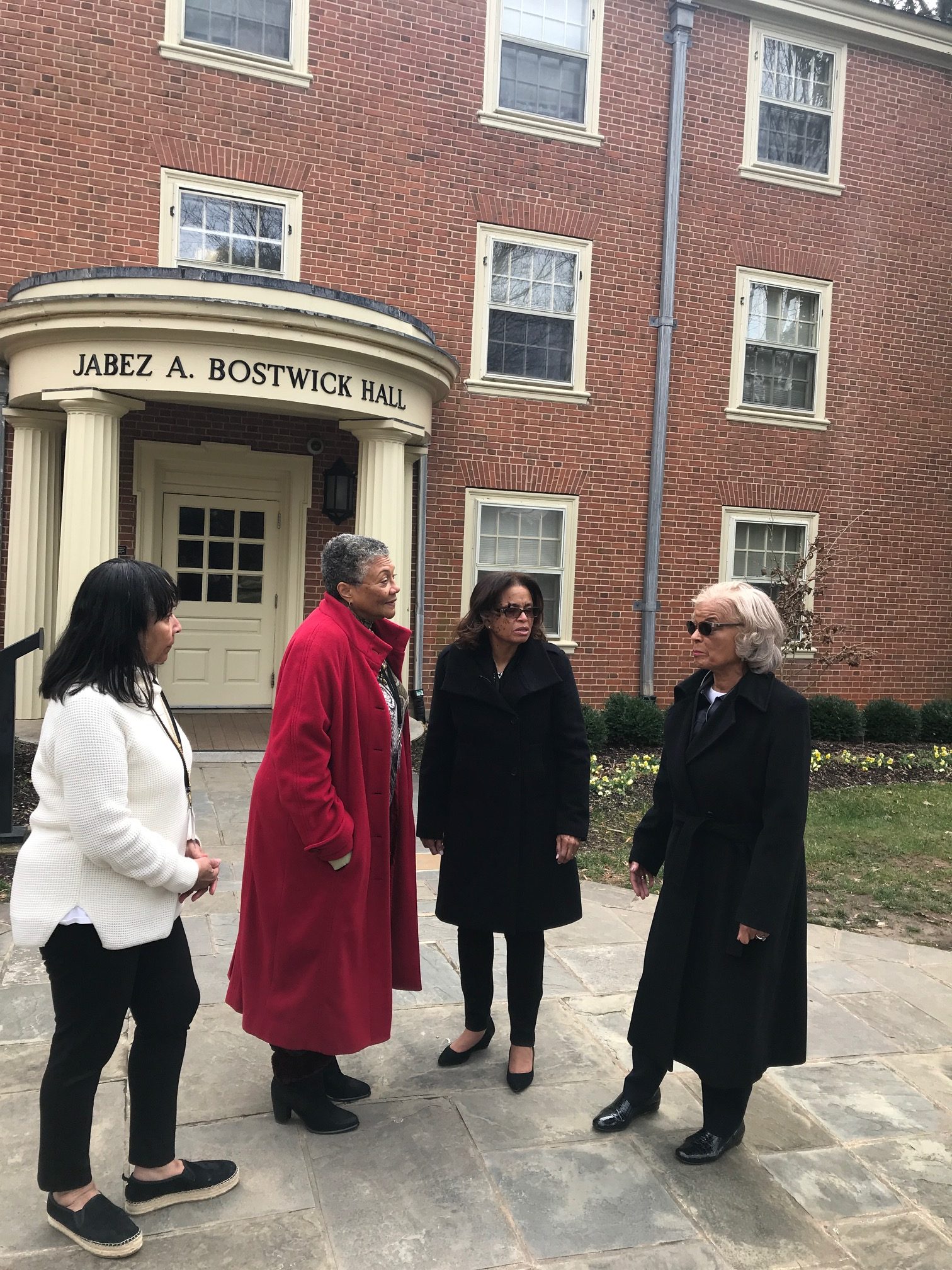 A photo of the distinguished alum outside of Bostwick Hall before their tour