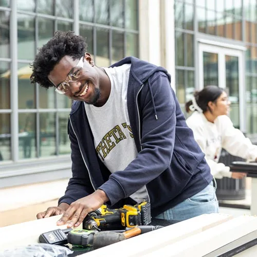 Wake Forest University Engineering students build beds on the patio at Wake Downtown.
