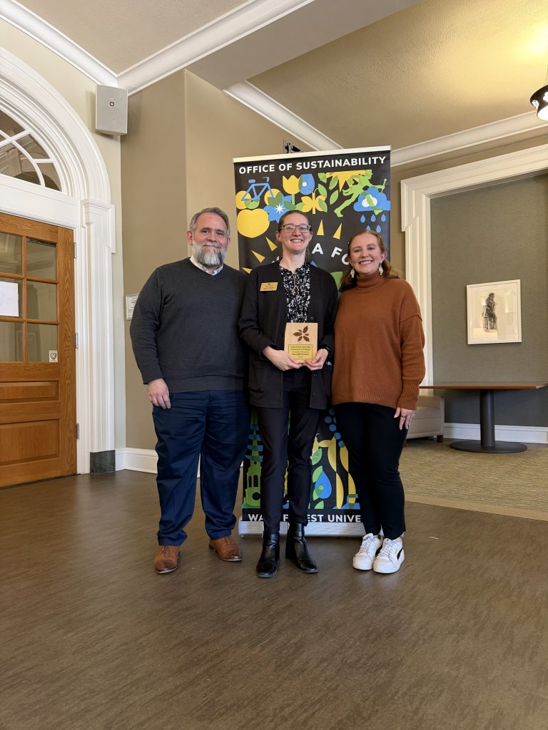 Dr. David Johnson, Meredith Parker (holding award plaque), and Louisa Steffen at the Annual Campus Sustainability Awards on March 18, 2026.
