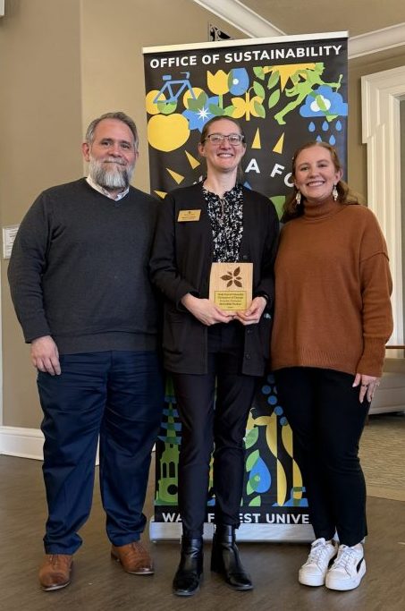 Dr. David Johnson, Meredith Parker (holding award plaque), and Louisa Steffen at the Annual Campus Sustainability Awards on March 18, 2026.