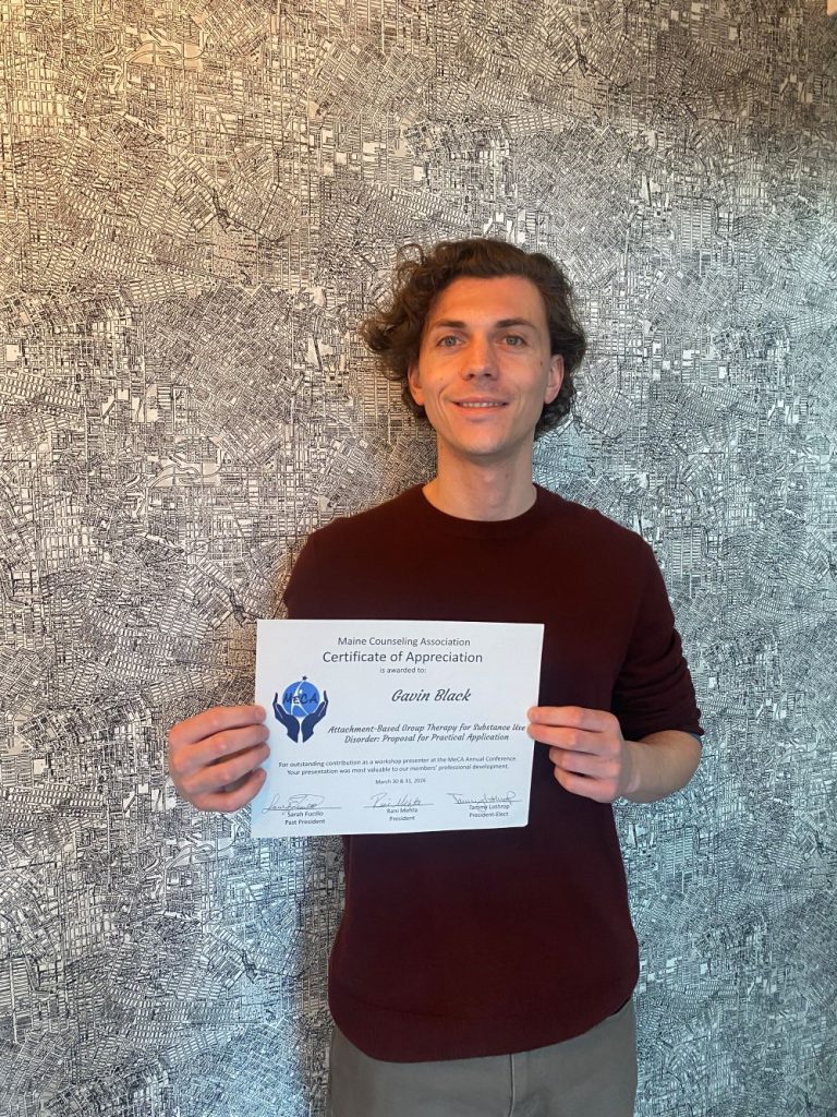 Online student Gavin Black holding certificate of appreciation.