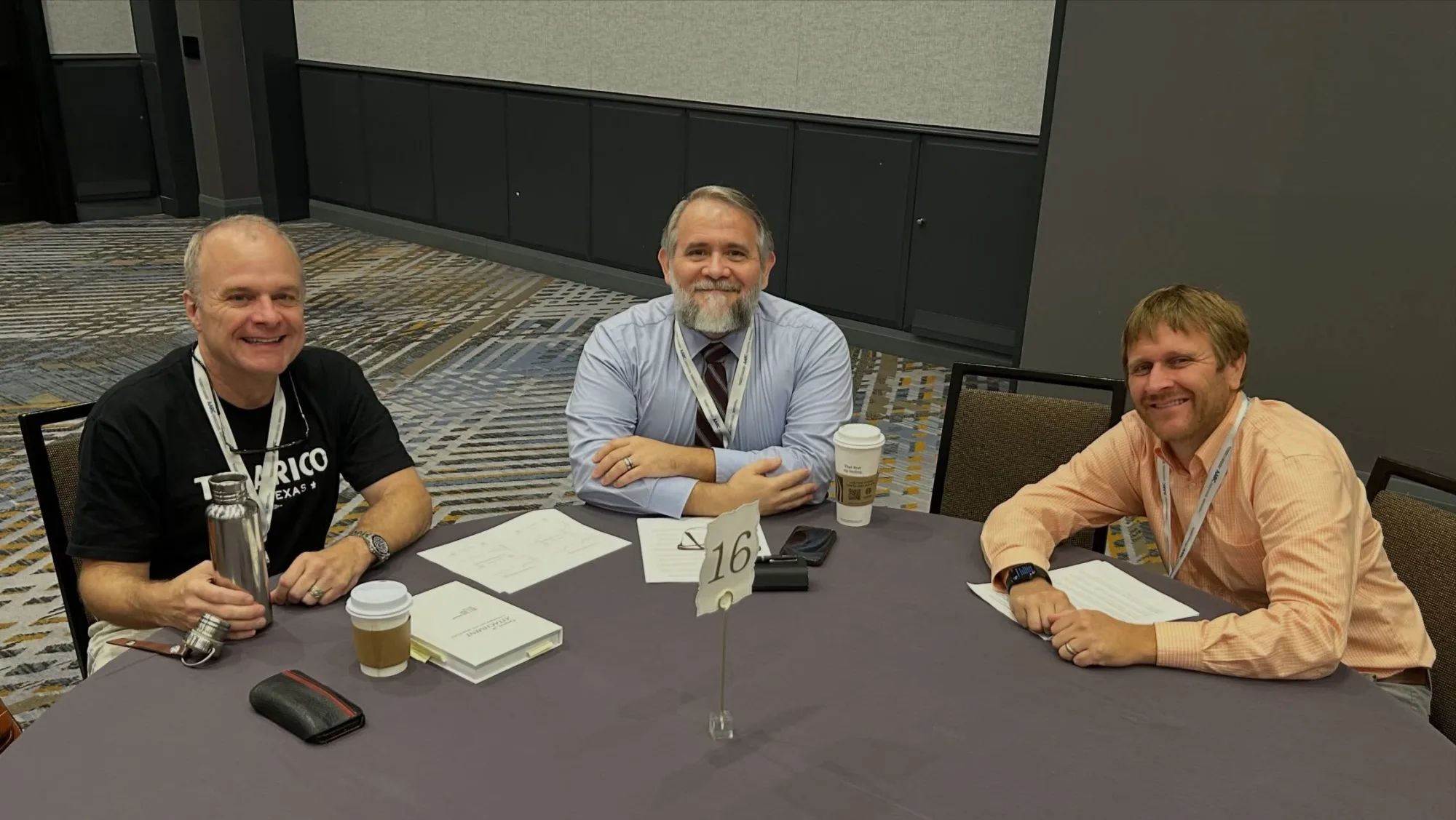 Drs. Johnson and Ivers seated at a table while attending a conference.