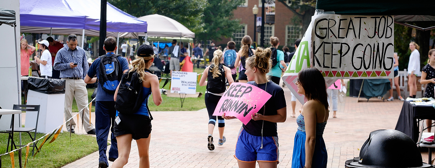 Students at Hit the Bricks for Brian event with sign Great Job Keep Going