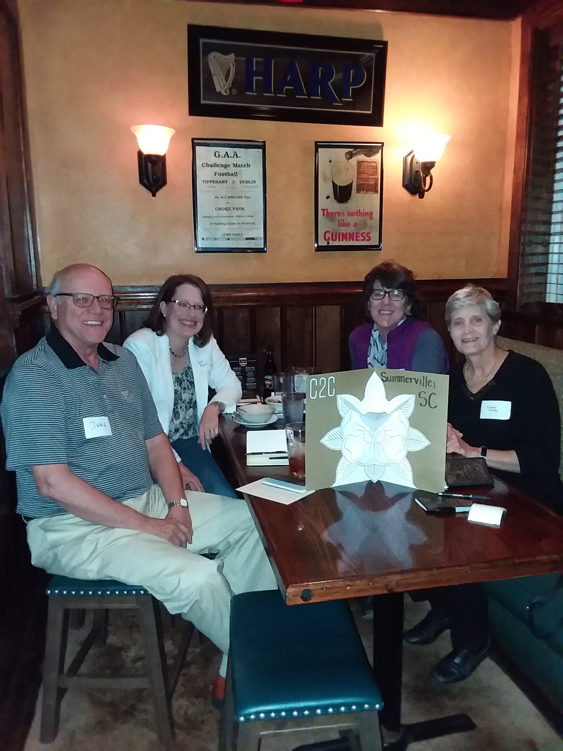 Group of four seated at a table at the C2C on March 10, 2020