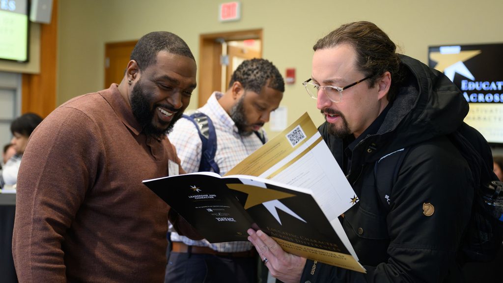 two men chat at a character education conference