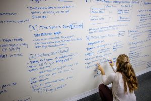 student writing on whiteboard