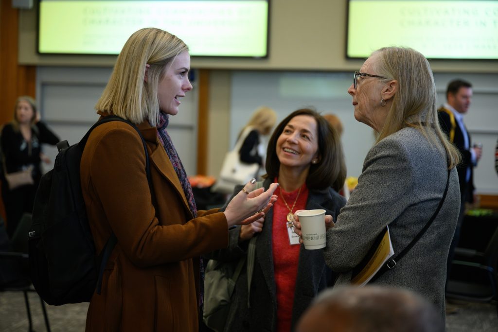people chat at a character education conference