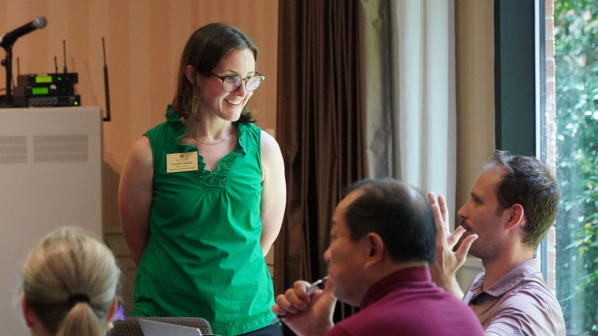 Liz Whiting listens to a participant during a character education workshop.
