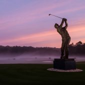 Arnold Palmer statue at sunset