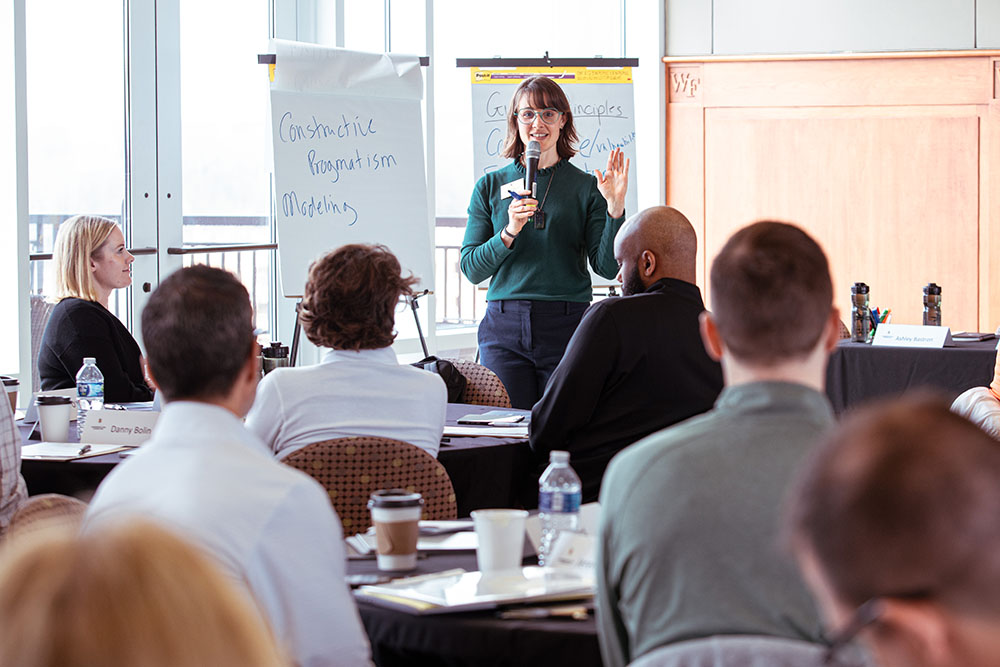 Liz Whiting welcomes attendees to the convening.