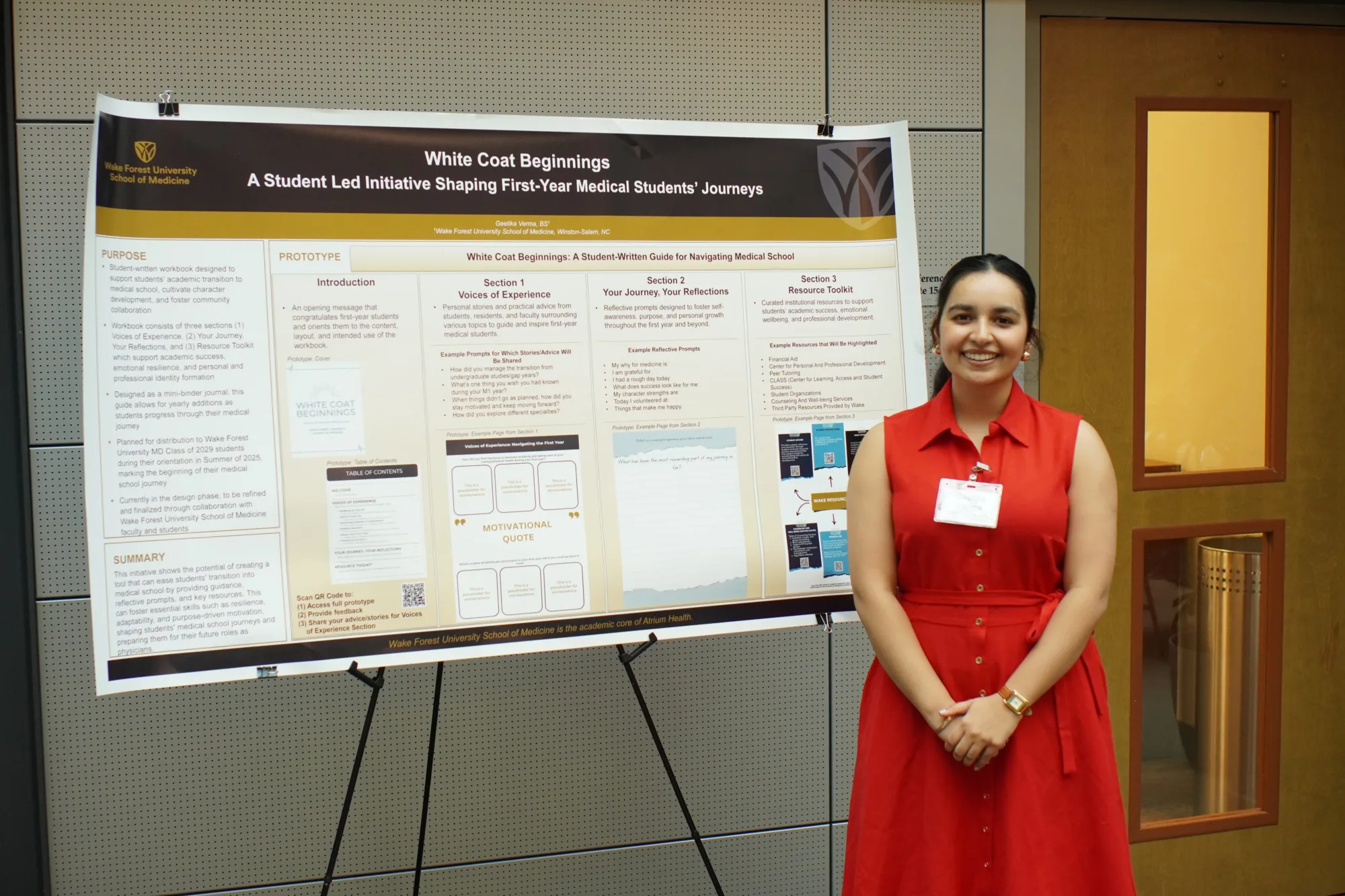 Geetika Verma ('28 MD) standing by her poster on White Coat Beginnings.