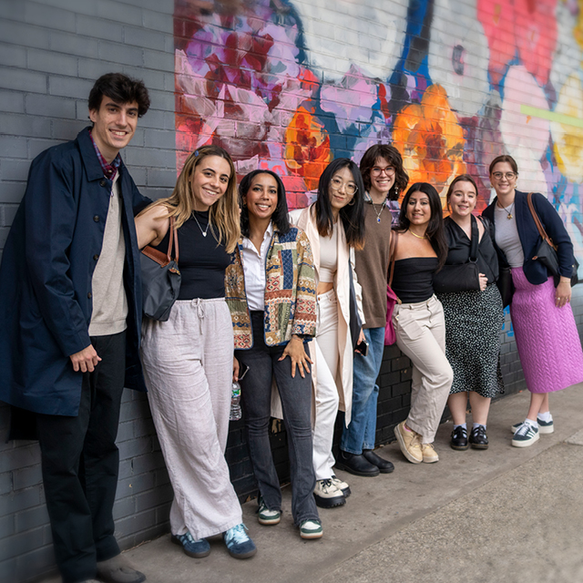 A group of students near a colorful mural in New York City