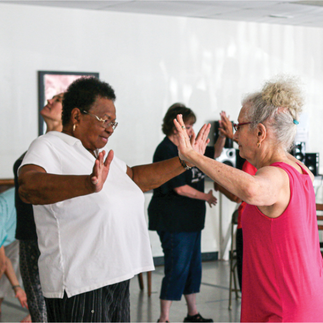 A group of people practice improvisational movement