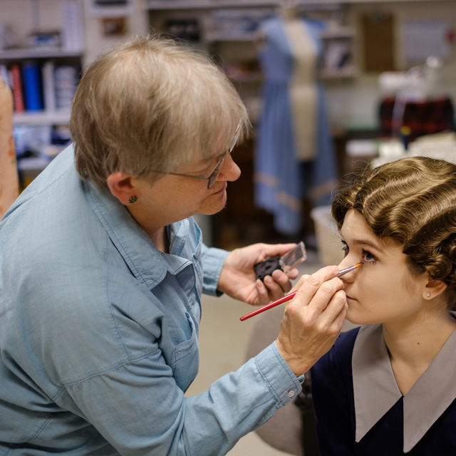 Mary Wayne-Thomas applying makeup for a student actor