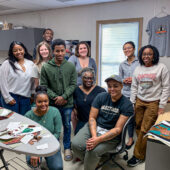 A diverse group of people at a quilt-making workshop