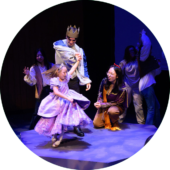 A young girl happily performs onstage with Wake Forest students