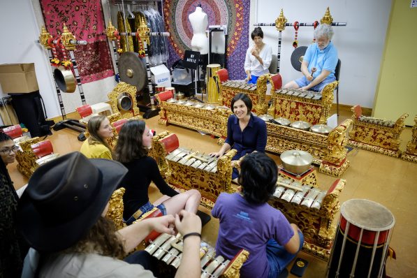 Students rehearse on gold and red gamelan instruments