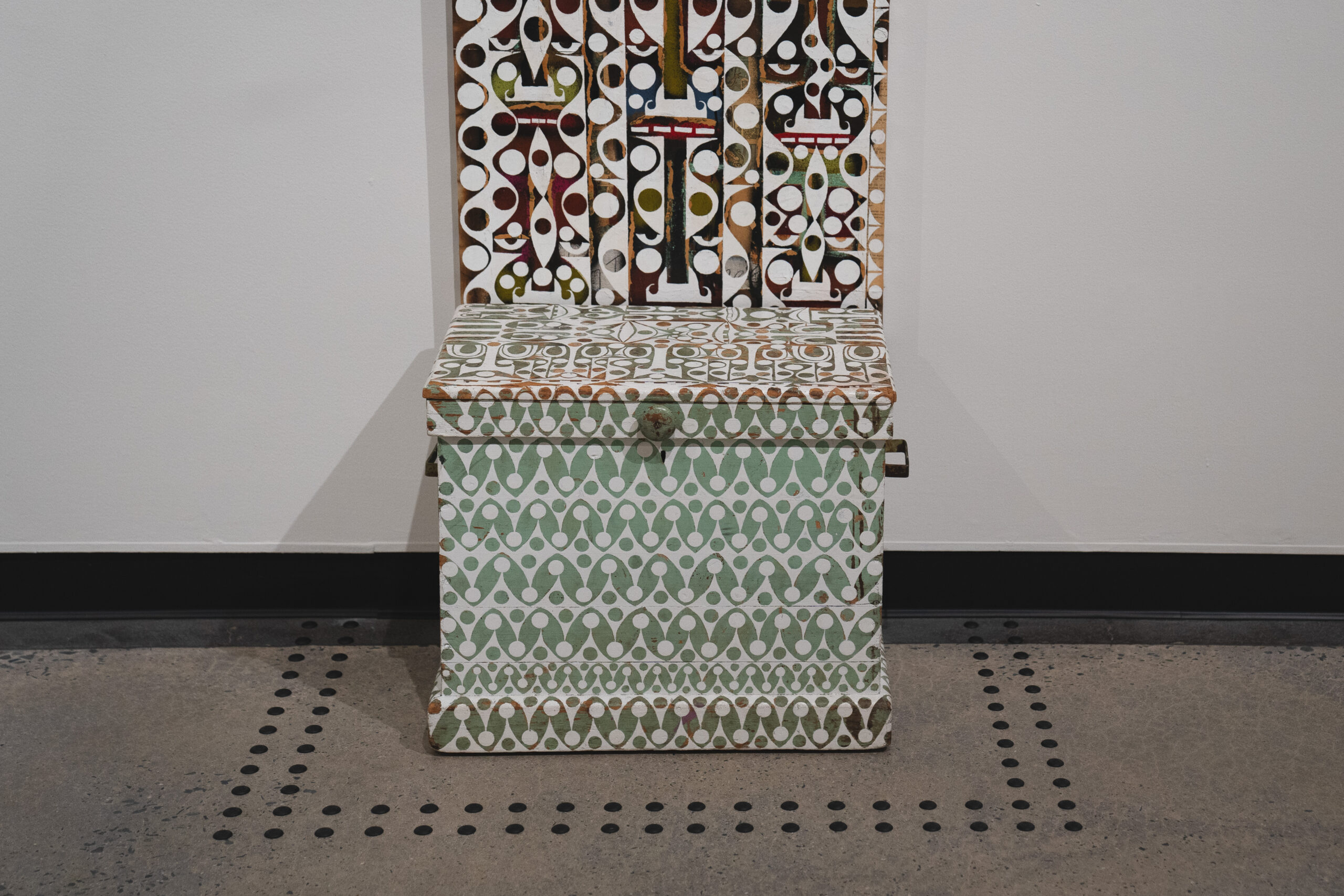 Two Rows of Warning Studs surrounding a wooden box sculpture