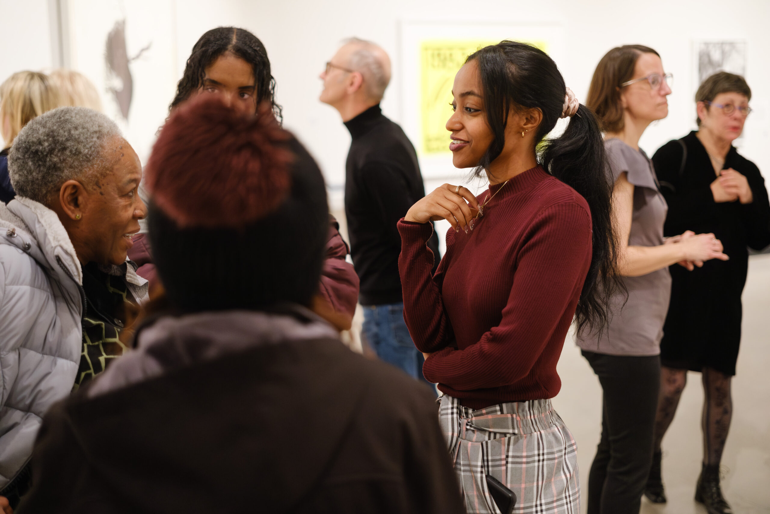 An energetic group of people at an art exhibition