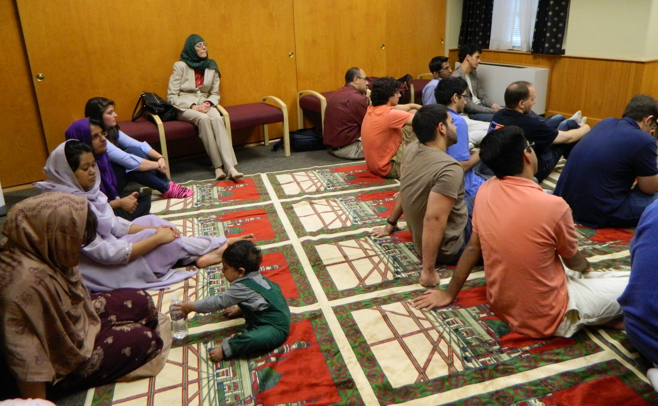 Image of Muslims listening to Friday sermon at Friday prayer service.