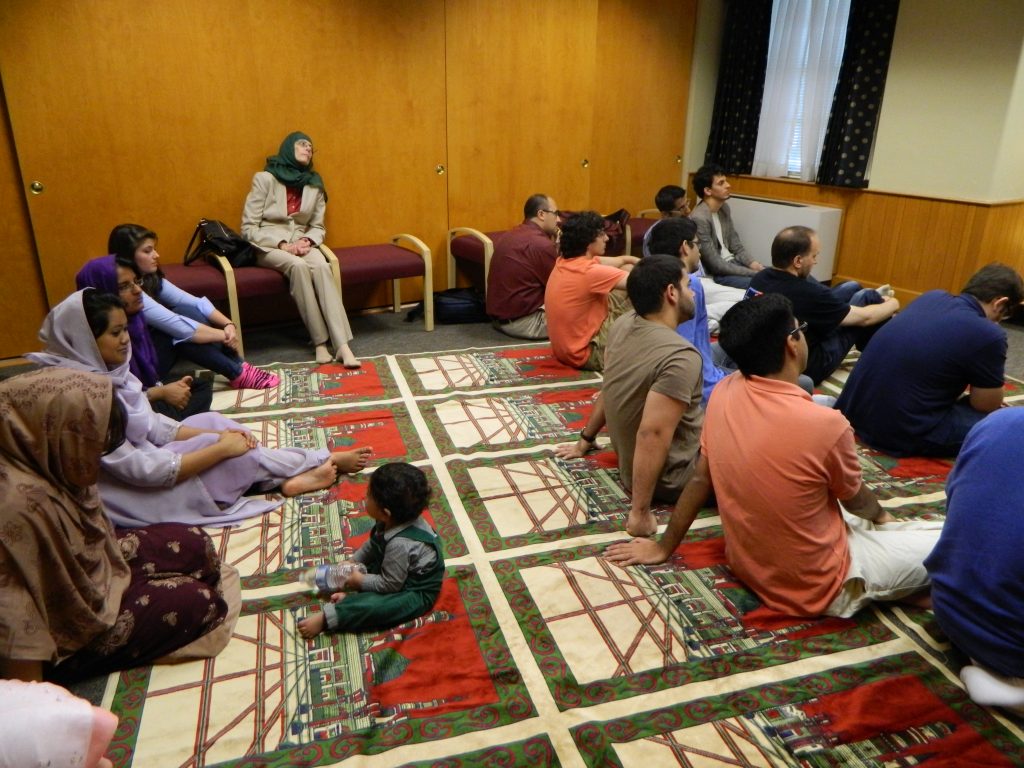 Image of Muslim community listening to Friday Sermon at Friday Prayer service.