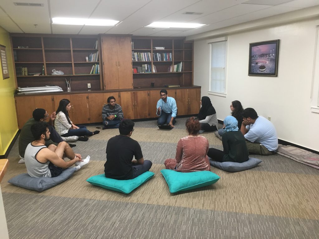 Image of Muslim students sitting in the Muslim Students Lounge for a discussion circle.