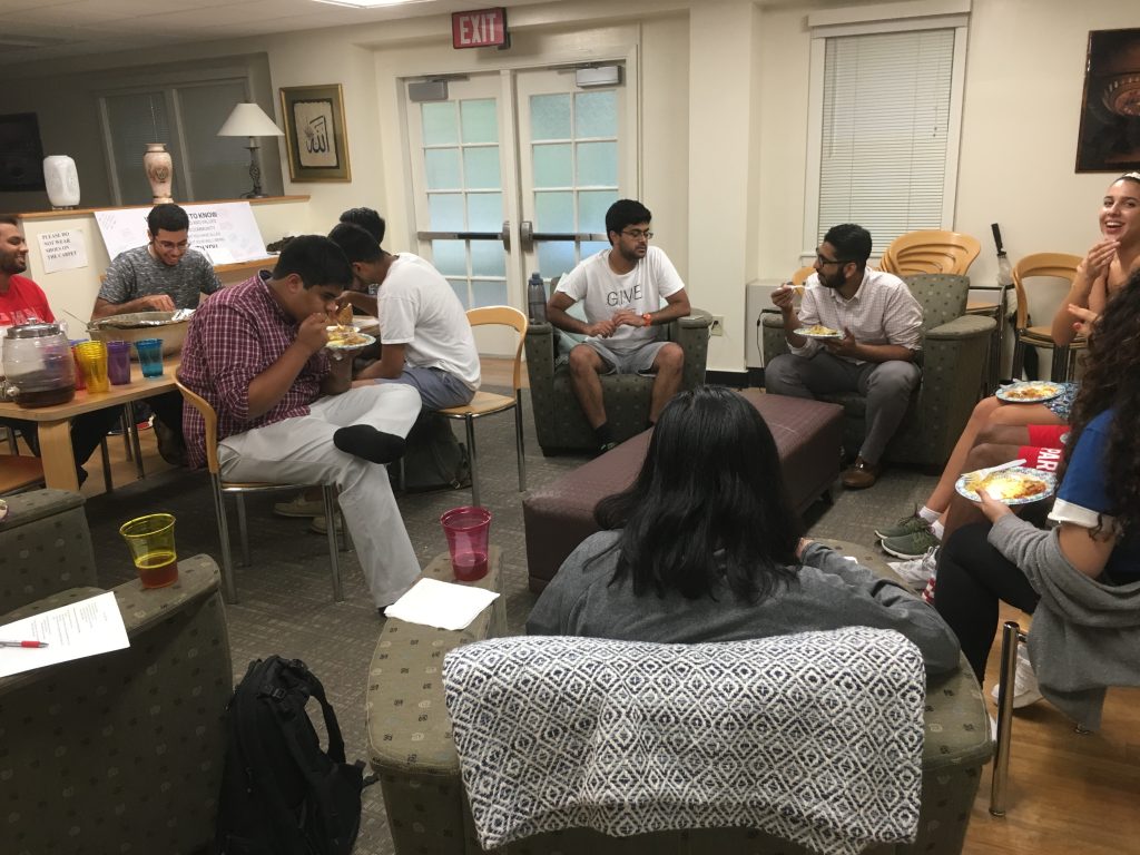 Muslim students in the Muslim Students Lounge eating and talking.