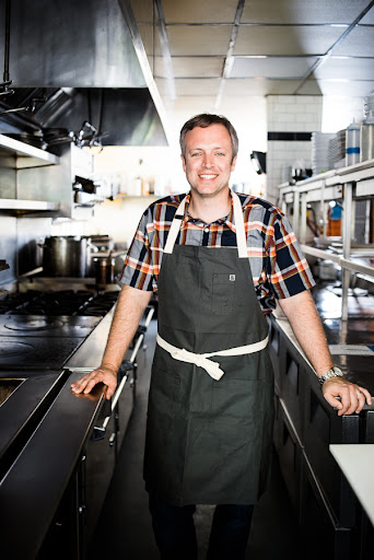 portrait of Chef William Dissen in a commercial kitchen setting