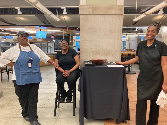 Dining team members pose for a photo before guests arrive to eat in the Pit.