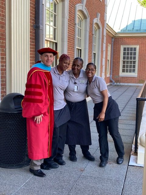 Dining team members pose for a photo with the WFU Registrar, Ken J. Gilson.