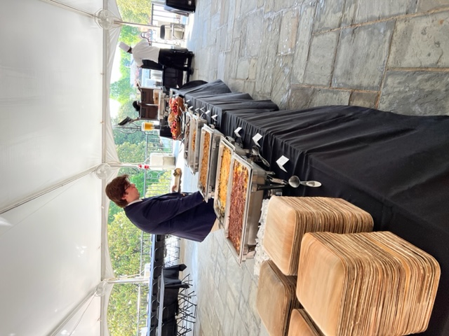 Buffet table set up under a tent for Commencement dining.
