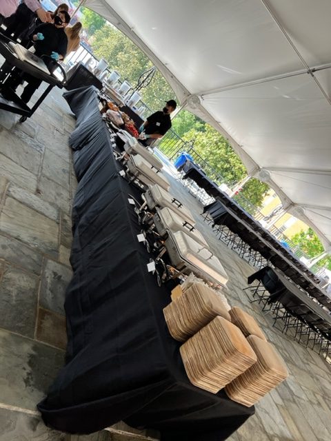 Buffet table set up under a tent for Commencement dining. 