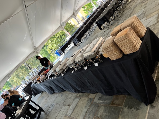 Buffet table set up under a tent for Commencement dining.