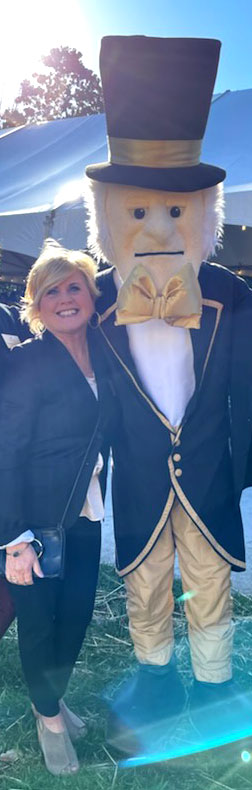 Photo of Conference & Event Services, Director, Sharon Englebert, standing with the Demon Deacon Mascot on Manchester Plaza.
