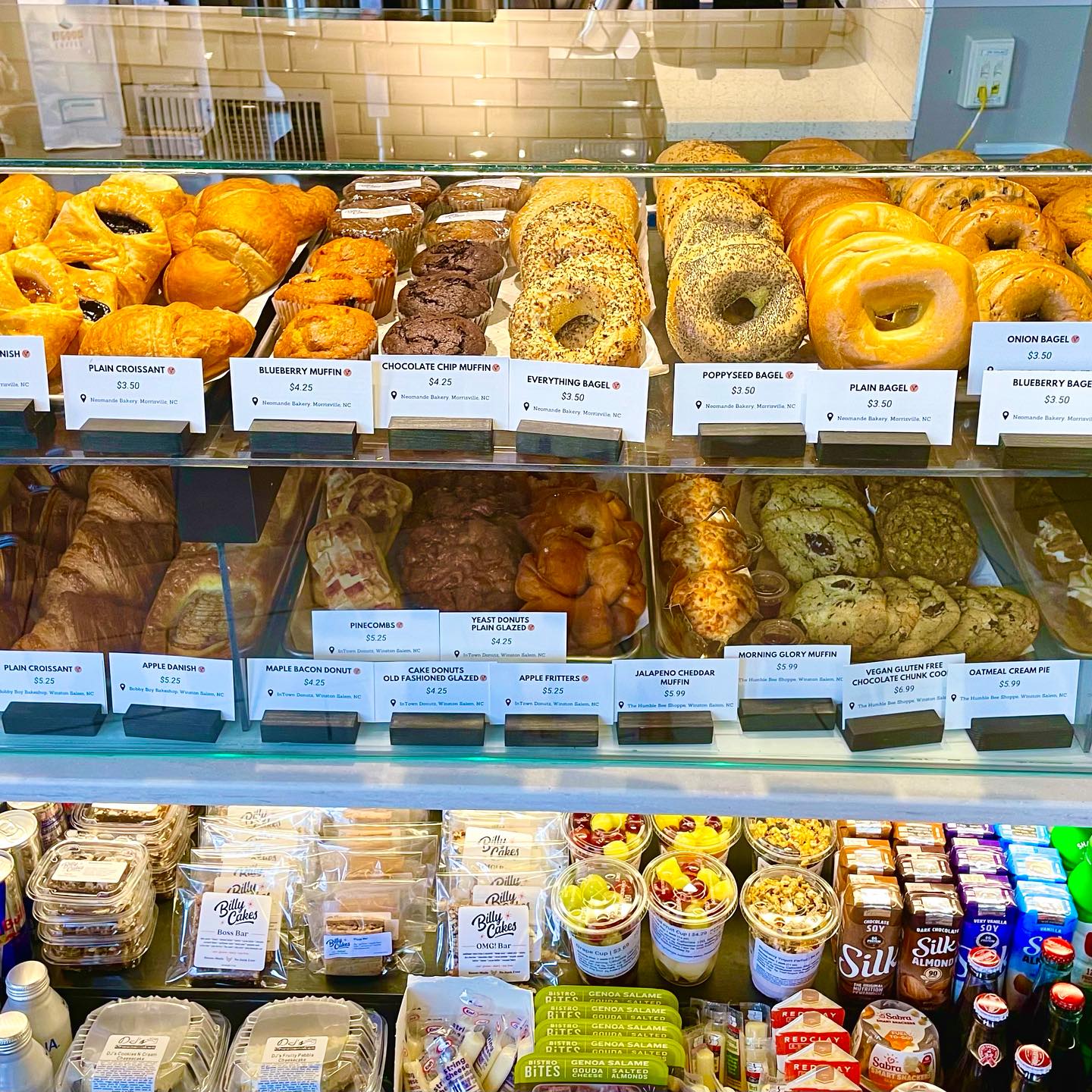 Photo of all the local pastries provided at Smith's Cafe. Each pastry is labeled with the type of pastry and where it is from in the Triad area.
