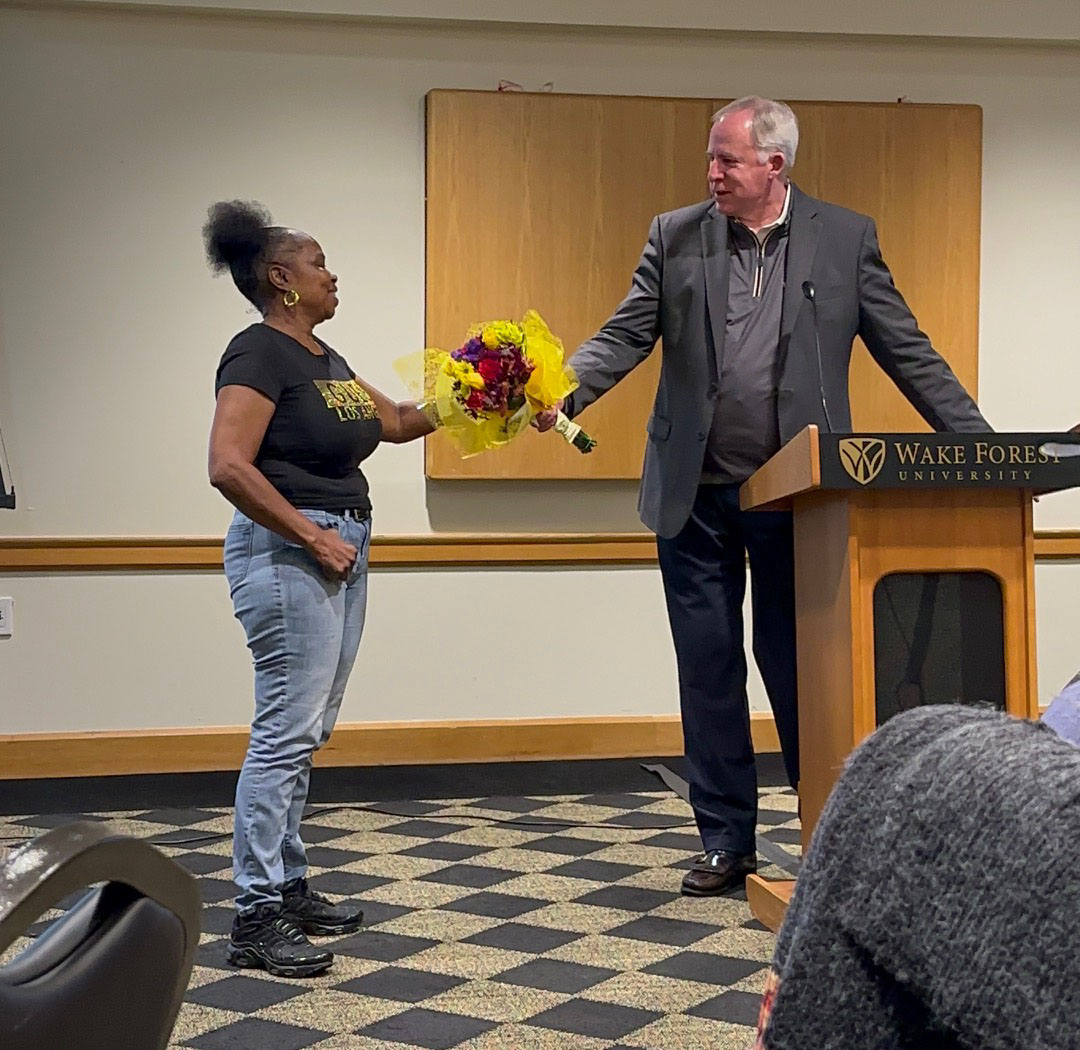 Photo of Wanda Samuels accepting her award for exemplary service from VP of Hospitality and Auxiliary Services, John Wise.