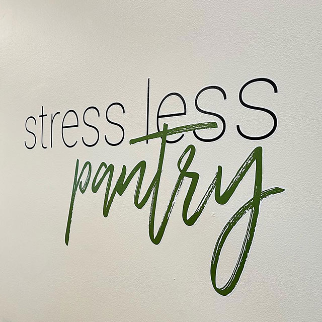 photo of stress less pantry decal on the wall in the dining hall.