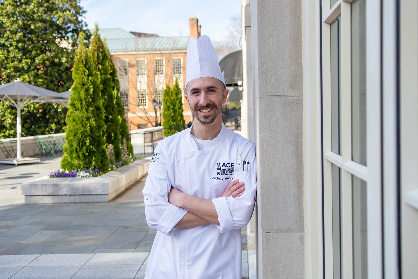 Photo of Chef Zachary Woodring outside the dining hall on a sunny day.