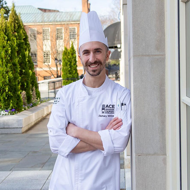 Photo of Chef Zachary Woodring outside the dining hall on a sunny day.