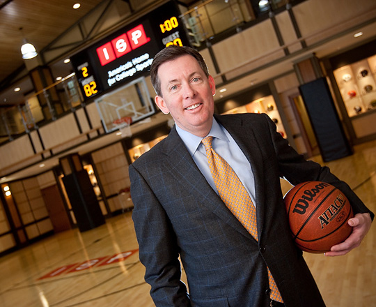 Ben Sutton in ISP headquarters holding a basketball