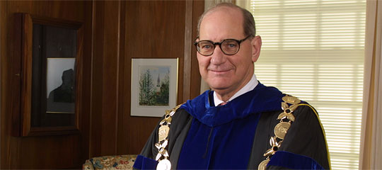 Thomas Hearn in his office wearing his academic robe