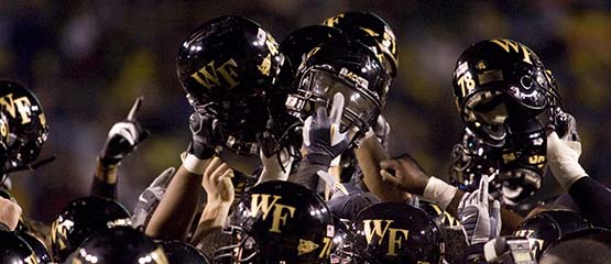 players hold helmets in the air