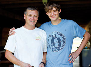 Son with arm around father