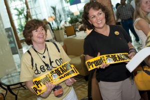 Sue Bray '83 (in yellow shirt) and Kim Powell '83 sell Demon Deacon bumper stickers