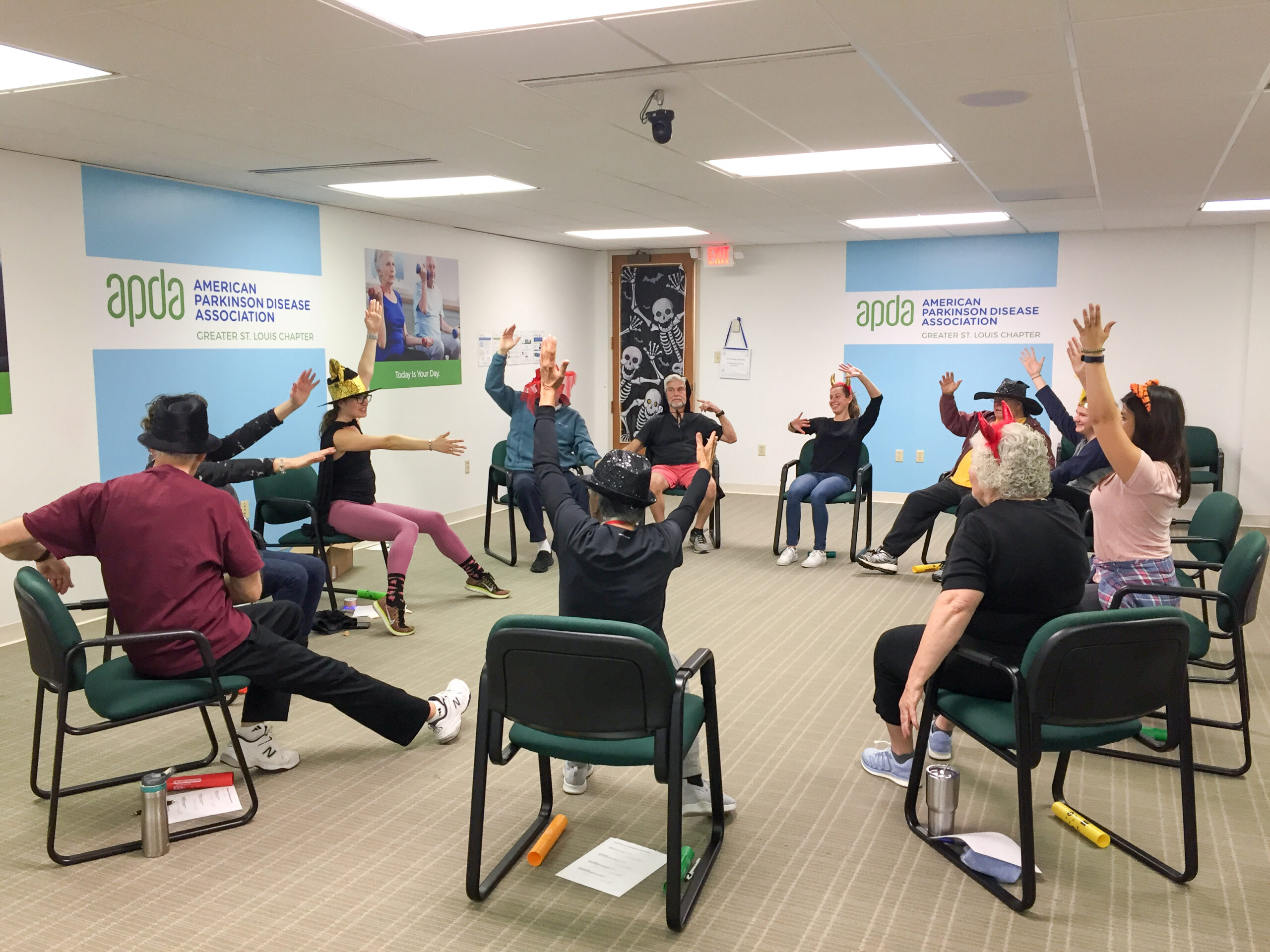 A group of seated people moving their arms