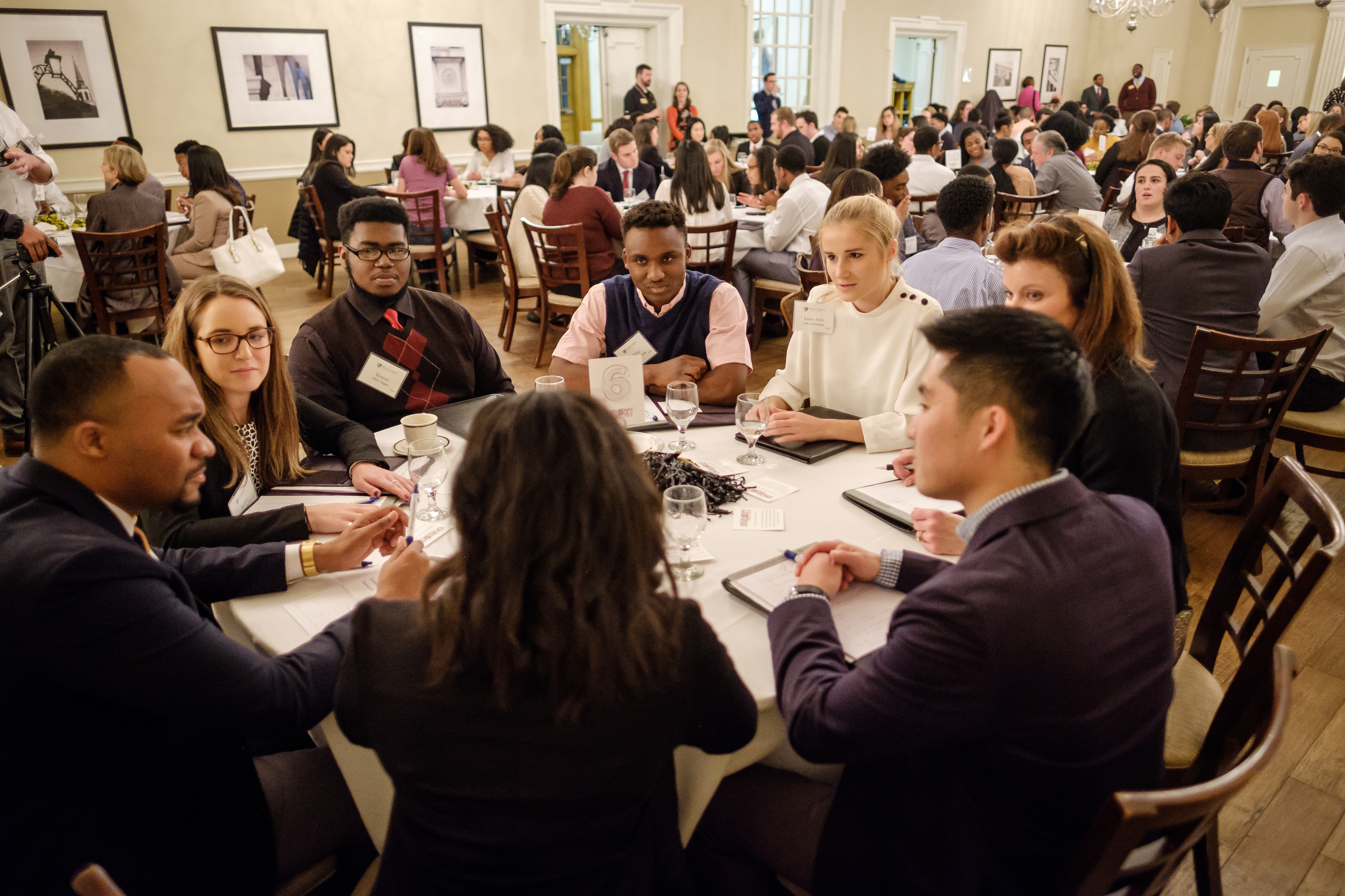 Students sitting at a round table during an event