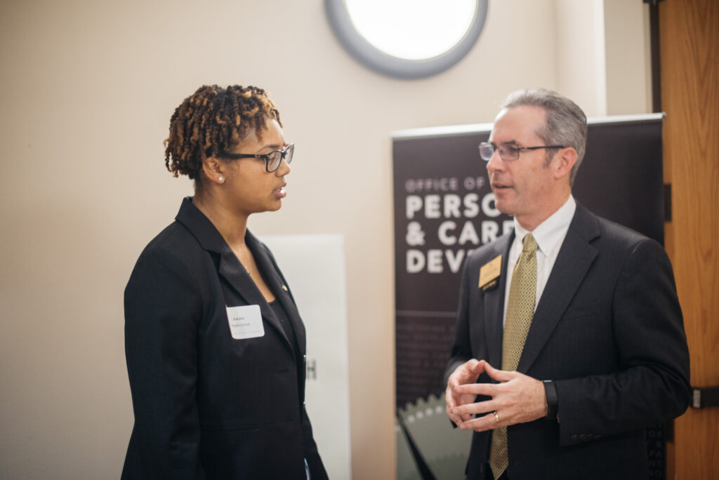 Patrick Sullivan, an OPCD career coach, meets with a student at an OPCD event.