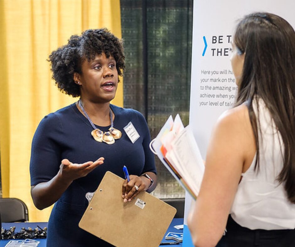 Student networking for an opportunity at a career event.